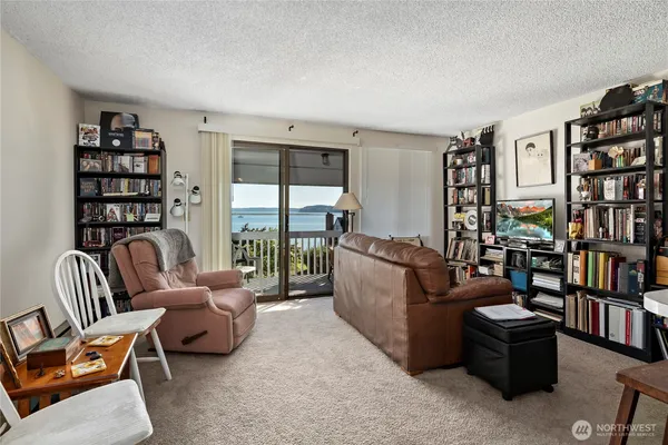 a living room with furniture and a book shelf