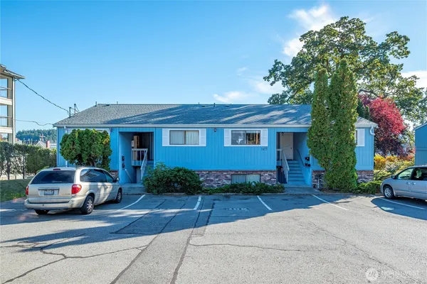 a front view of a house with a garden