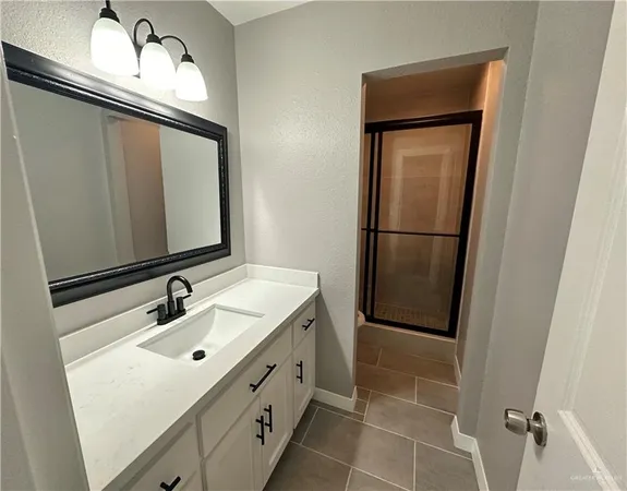 a bathroom with a sink a mirror and a shower