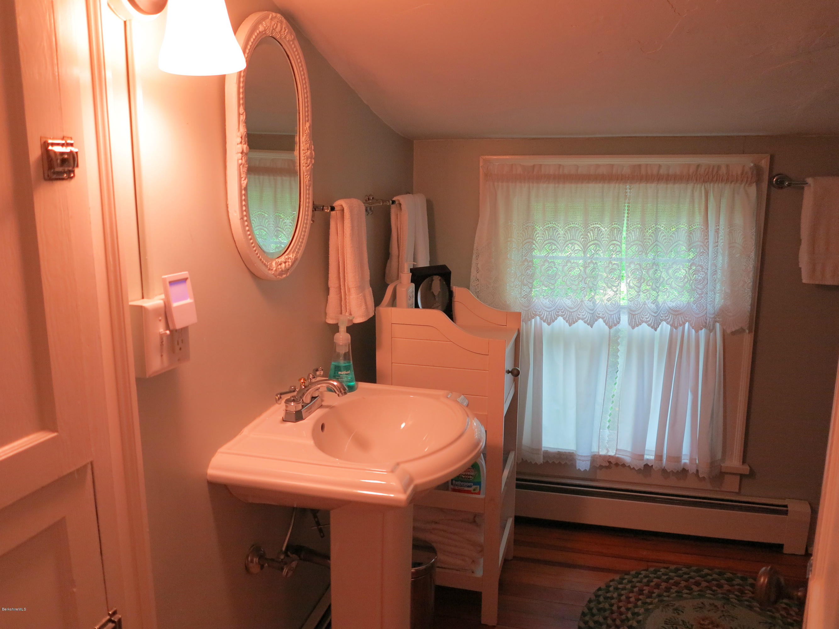 4 Tyringham Road Monterey, MA 01245 - Photo 13 of 26 a bathroom with a sink a mirror and a bathtub