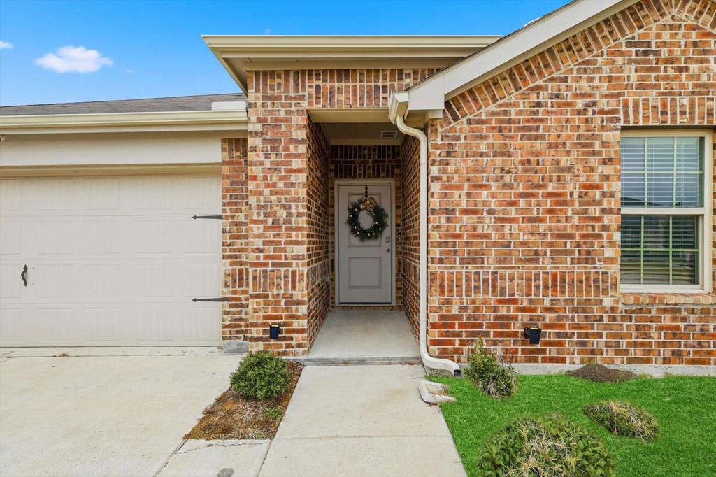 2416 Wildhaven Road Crandall, TX 75114 - Photo 3 of 35 a front view of a house with a garden