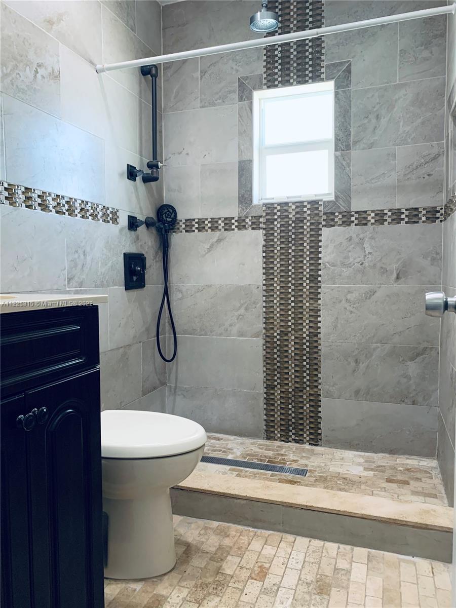 1315 Northwest 86th Street Miami, FL 33147 - Photo 3 of 16 a bathroom with a toilet sink and shower
