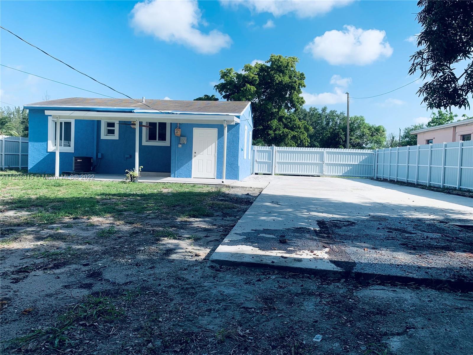 1315 Northwest 86th Street Miami, FL 33147 - Photo 8 of 16 a view of a yard in front of a house with large tree