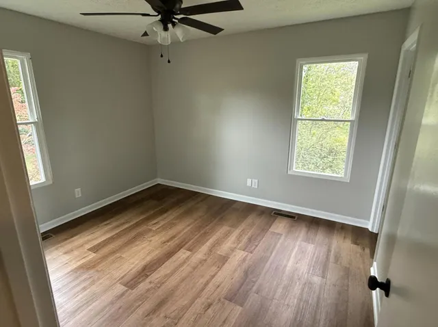 wooden floor in an empty room with a window