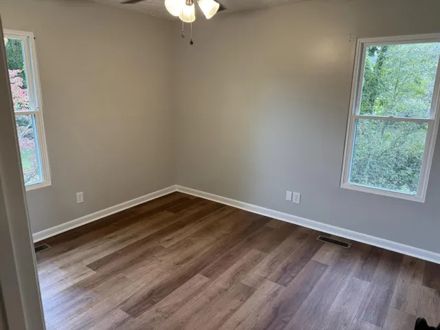 wooden floor in an empty room with a window
