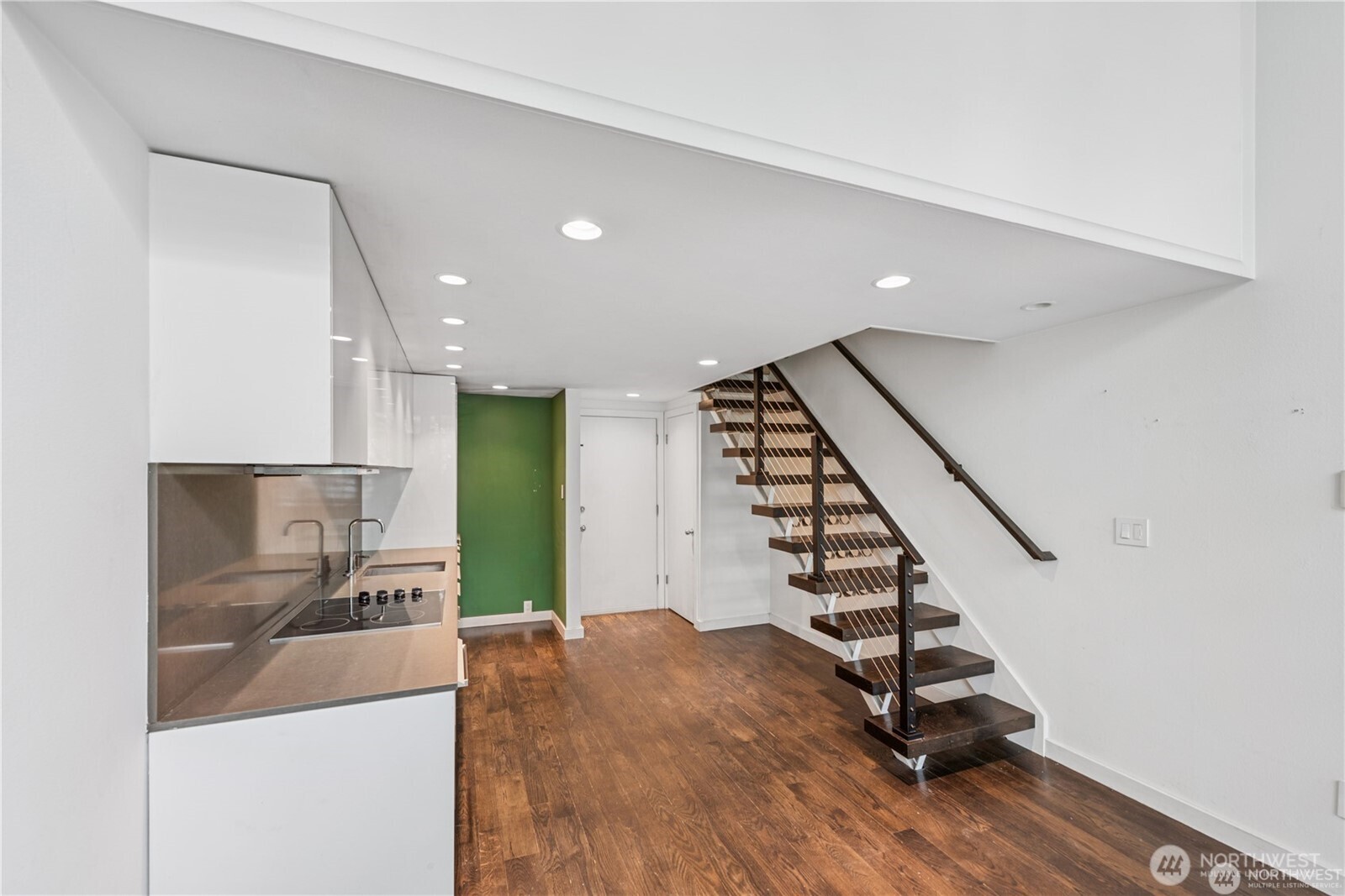 1000 Union Street, Unit 402 Seattle, WA 98101 - Photo 4 of 10 a view of a hallway with stairs and a kitchen view