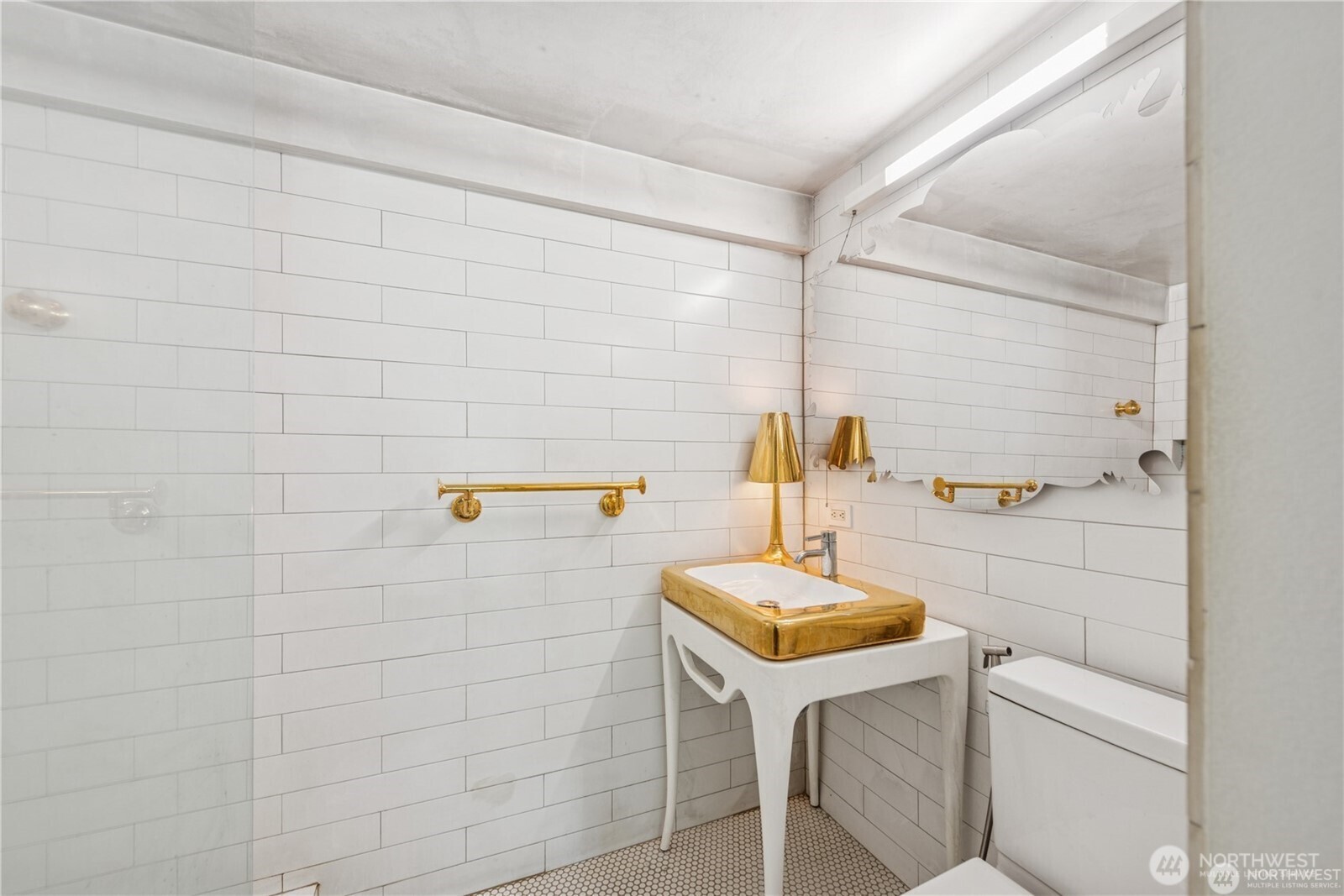 1000 Union Street, Unit 402 Seattle, WA 98101 - Photo 7 of 10 a bathroom with a sink a toilet and mirror