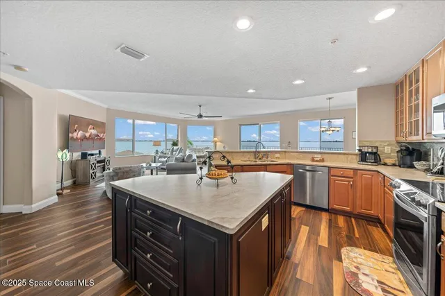 a living room with furniture kitchen and a table