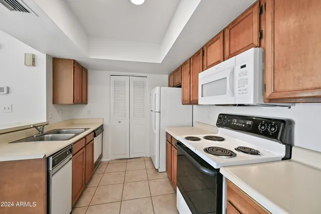 a kitchen with a stove and a refrigerator