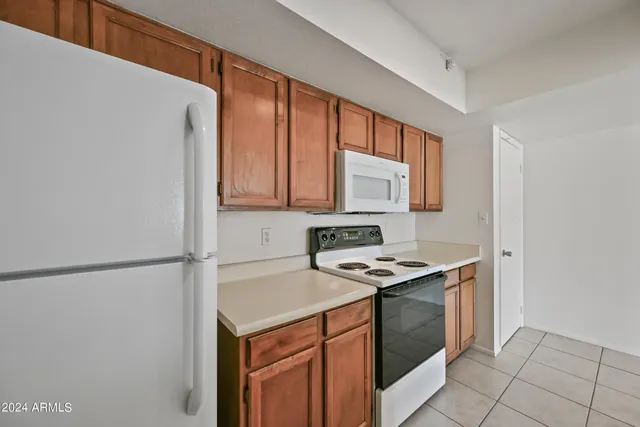 a kitchen with stainless steel appliances granite countertop a stove a refrigerator and a sink