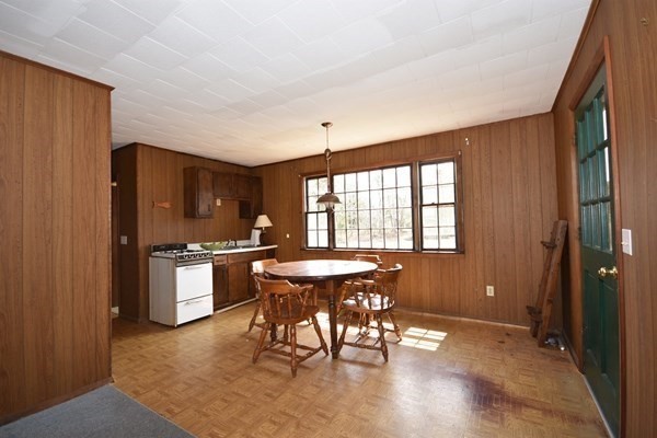 28 Harbor View Road Bourne, MA 02559 - Photo 6 of 14 a dining room with a wooden table and chairs