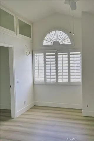 a view of a livingroom with a window and a ceiling fan