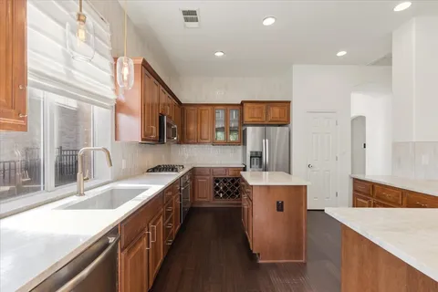 a kitchen with a sink stove and refrigerator