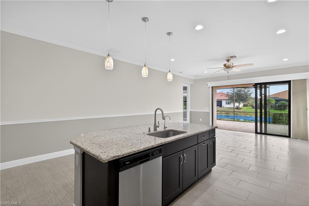 1412 Lucena Lane South Naples, FL 34113 - Photo 11 of 50 Kitchen with large island, pendant light fixtures, granite counters, tile backsplash, stainless steel appliances, pantry and tranquil water views.