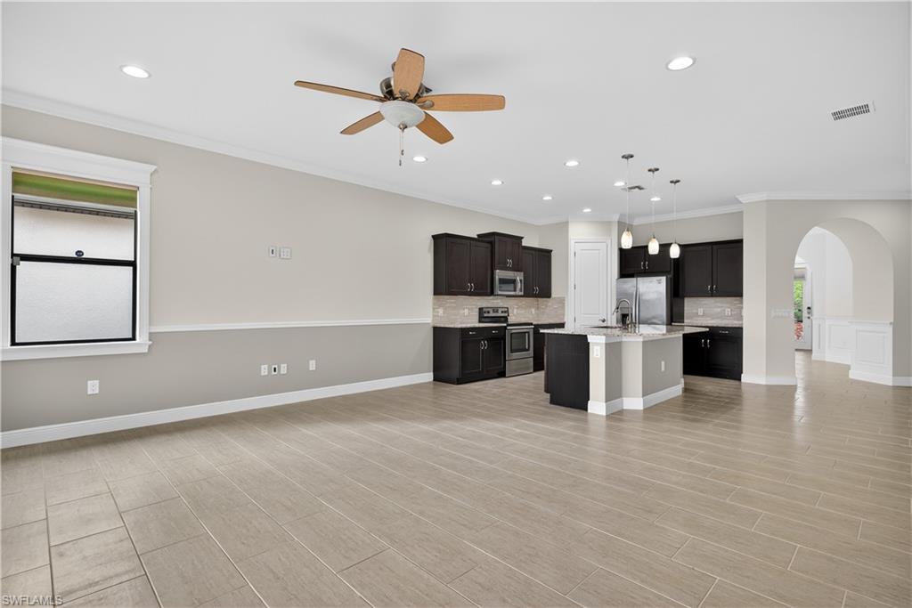 1412 Lucena Lane South Naples, FL 34113 - Photo 48 of 50 Open floor plan, large living area, arched doorways, recessed lighting, and tile floors