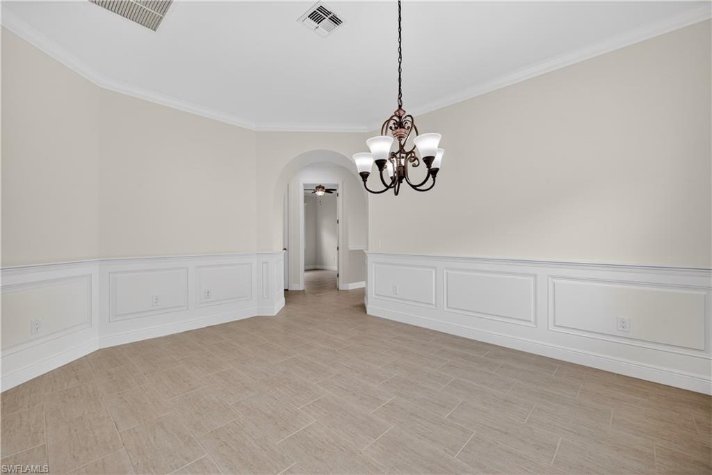 1412 Lucena Lane South Naples, FL 34113 - Photo 16 of 50 Flex room with hand crafted wainscoted walls and arched walkways. This room can be used as a formal dining room, office, den or hobby room.