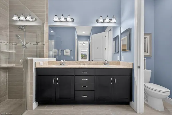 a bathroom with a double vanity sink and a toilet