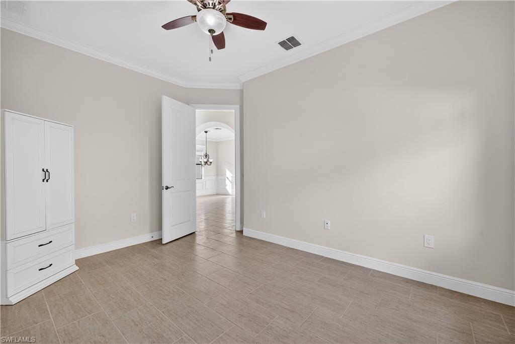1412 Lucena Lane South Naples, FL 34113 - Photo 23 of 49 Guest bedroom with tile floors, crown molding and ceiling fan.