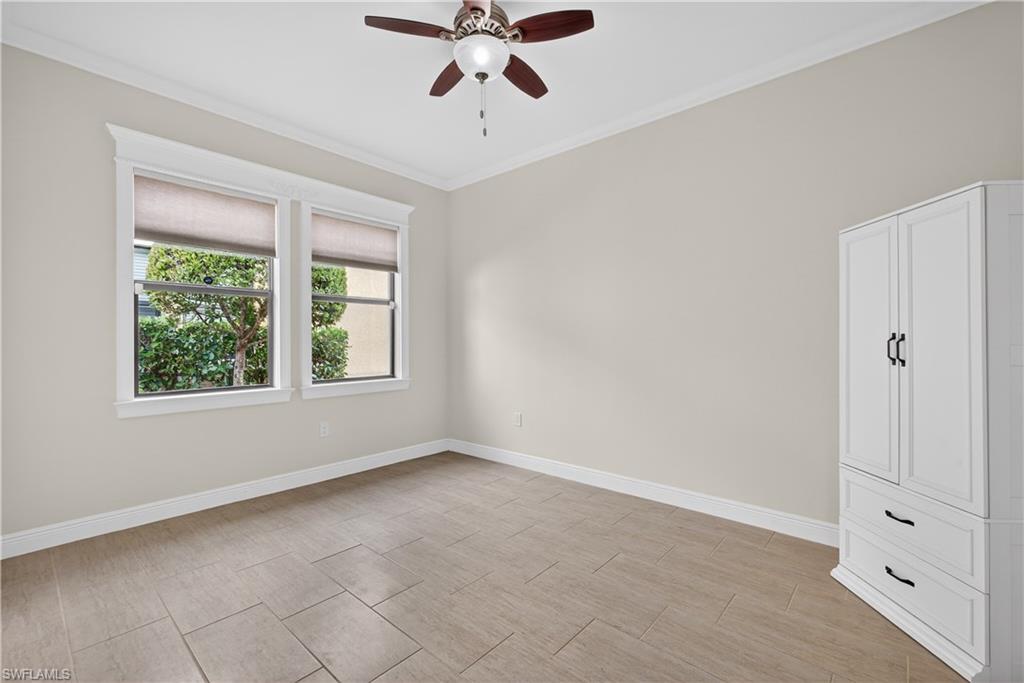 1412 Lucena Lane South Naples, FL 34113 - Photo 23 of 50 Guest bedroom with tile floors, crown molding and ceiling fan.
