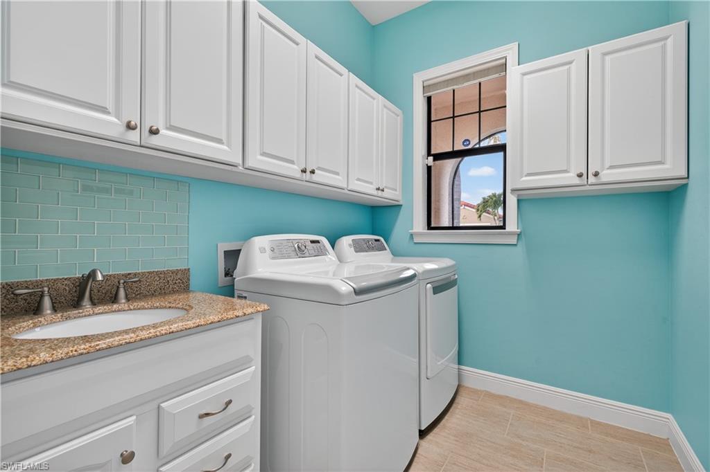 1412 Lucena Lane South Naples, FL 34113 - Photo 27 of 49 Laundry room featuring sink, plenty of cabinets, washer and dryer