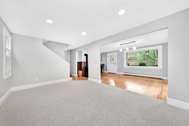 an empty room with windows and garden view