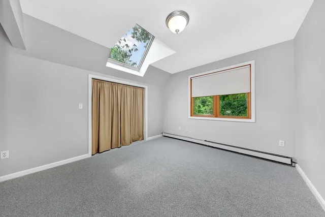 an empty room with windows and entrance