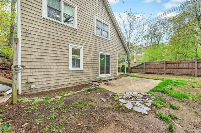 a view of a house with a yard and wooden fence
