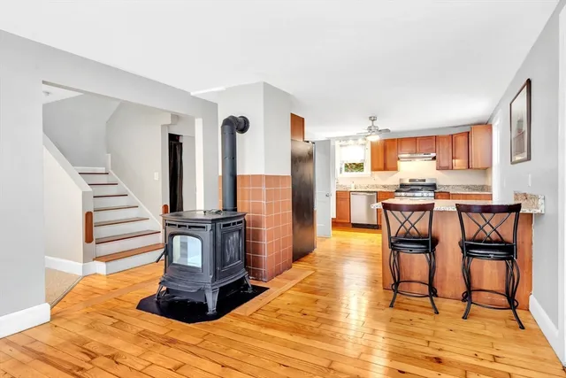 a view of a kitchen with furniture and wooden floor