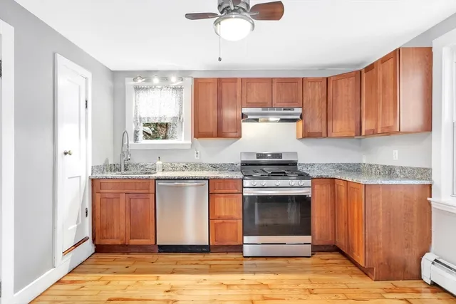 a kitchen with stainless steel appliances granite countertop a stove a sink and a refrigerator