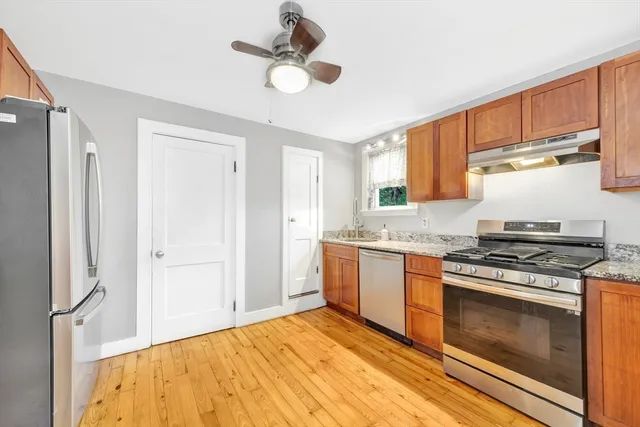 a kitchen with stainless steel appliances granite countertop a stove sink and refrigerator