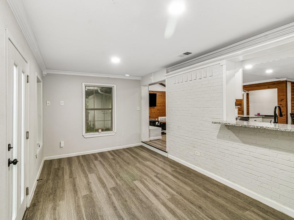 203 Hogg Street Streetman, TX 75859 - Photo 19 of 36 a view of a room with wooden floor and a window
