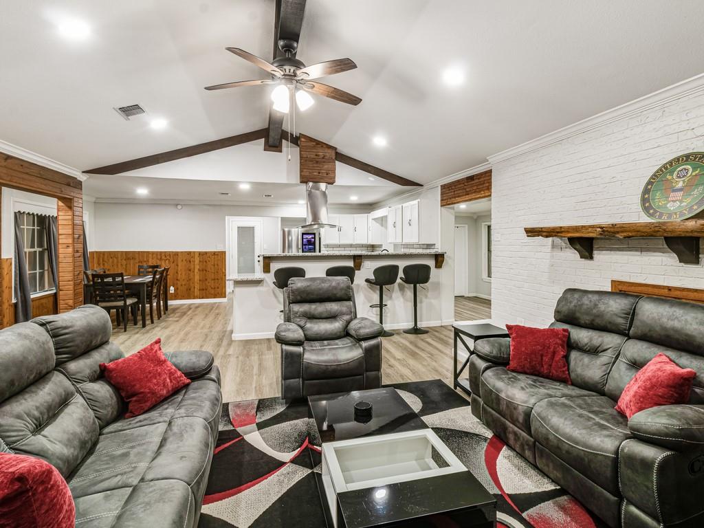 203 Hogg Street Streetman, TX 75859 - Photo 22 of 36 a living room with furniture and a chandelier