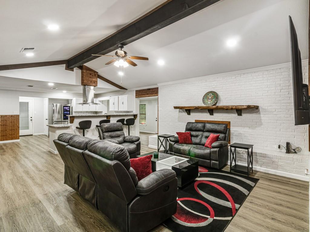 203 Hogg Street Streetman, TX 75859 - Photo 23 of 36 Living room featuring light wood-style floors, recessed lighting, a ceiling fan, and brick wall