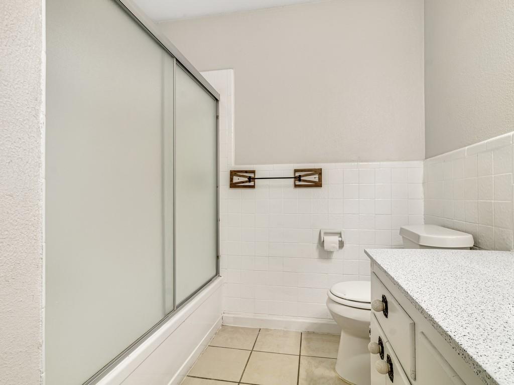 203 Hogg Street Streetman, TX 75859 - Photo 26 of 36 a bathroom with a granite countertop sink and toilet