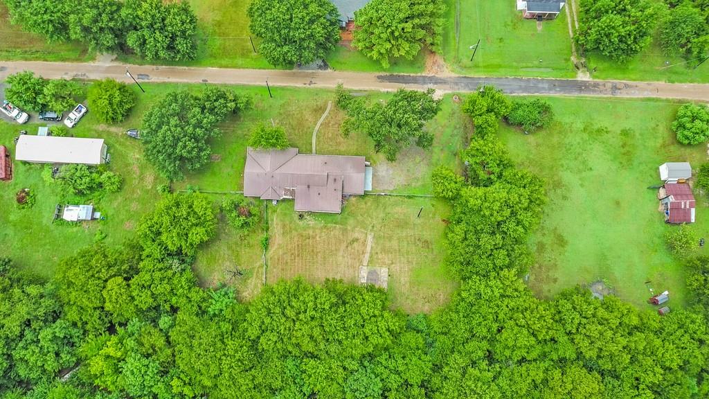 203 Hogg Street Streetman, TX 75859 - Photo 2 of 36 an aerial view of a house with a yard basket ball court and outdoor seating