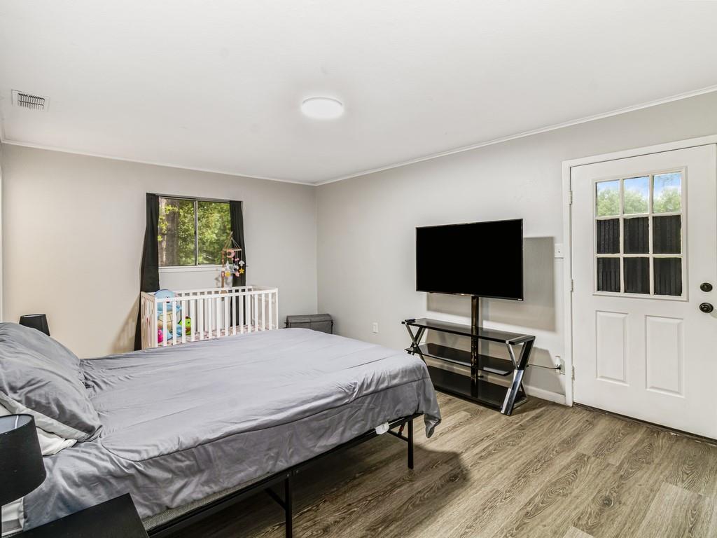 203 Hogg Street Streetman, TX 75859 - Photo 31 of 36 a bedroom with a bed and a flat screen tv