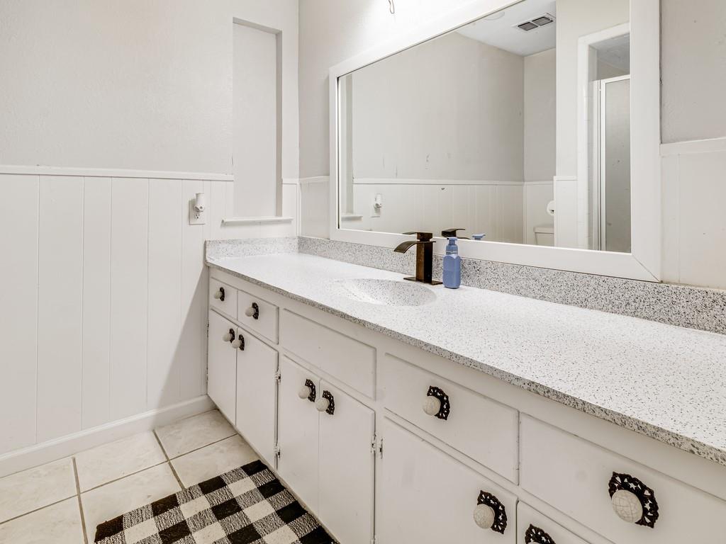 203 Hogg Street Streetman, TX 75859 - Photo 34 of 36 a bathroom with a sink and a mirror