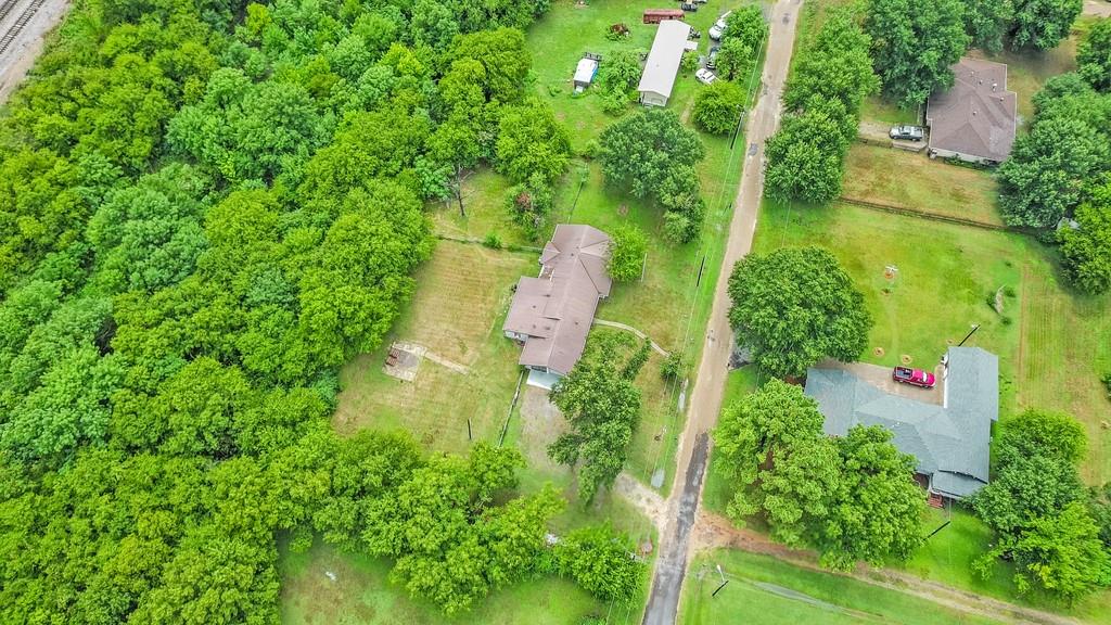 203 Hogg Street Streetman, TX 75859 - Photo 3 of 36 an aerial view of residential house with outdoor space and trees all around