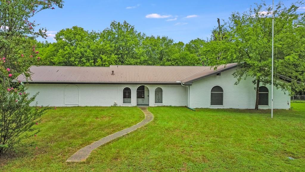 203 Hogg Street Streetman, TX 75859 - Photo 4 of 36 a house view with a garden space