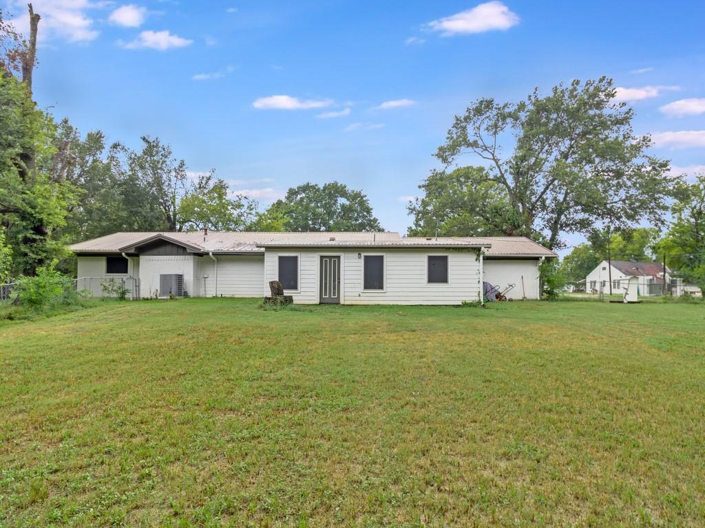 203 Hogg Street Streetman, TX 75859 - Photo 6 of 36 a front view of a house with a garden