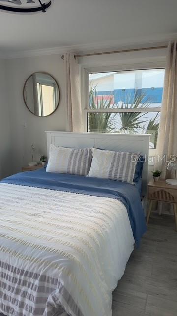 403 63rd Street Holmes Beach, FL 34217 - Photo 14 of 81 a bedroom with a bed and a painting on the wall