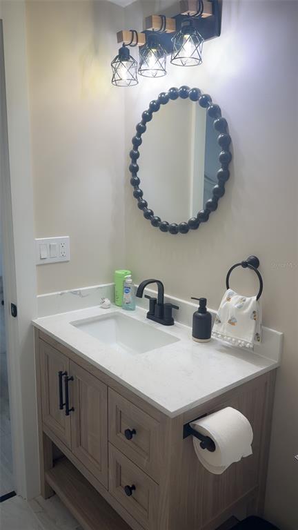 403 63rd Street Holmes Beach, FL 34217 - Photo 25 of 81 a bathroom with a sink and a mirror