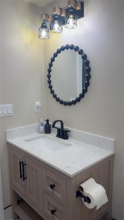 403 63rd Street Holmes Beach, FL 34217 - Photo 28 of 81 a bathroom with a sink a vanity and a mirror