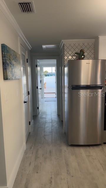 403 63rd Street Holmes Beach, FL 34217 - Photo 30 of 81 a view of a refrigerator in kitchen and wooden floor