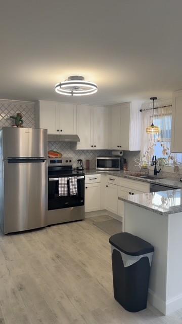 403 63rd Street Holmes Beach, FL 34217 - Photo 31 of 81 a kitchen with stainless steel appliances granite countertop a sink stove and refrigerator