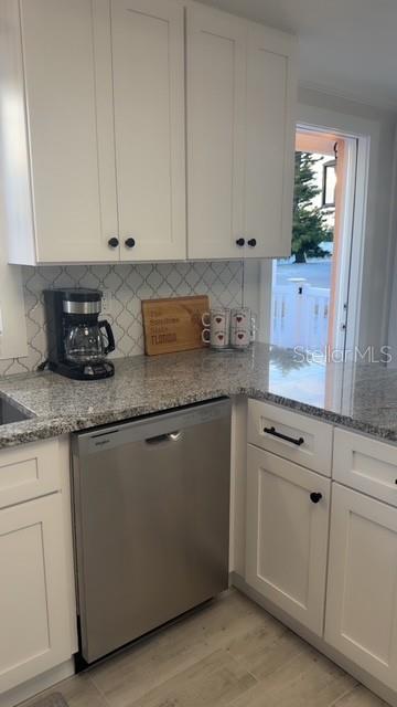403 63rd Street Holmes Beach, FL 34217 - Photo 34 of 81 a kitchen with granite countertop white cabinets and a sink