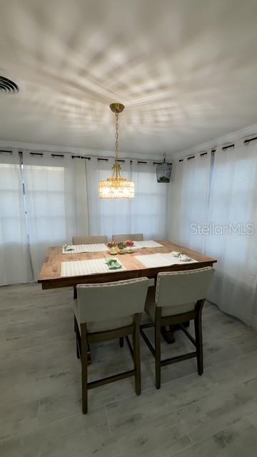 403 63rd Street Holmes Beach, FL 34217 - Photo 40 of 81 a room with a wooden table and chairs