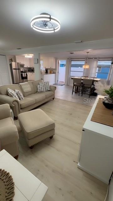 403 63rd Street Holmes Beach, FL 34217 - Photo 49 of 81 a living room with furniture and a chandelier