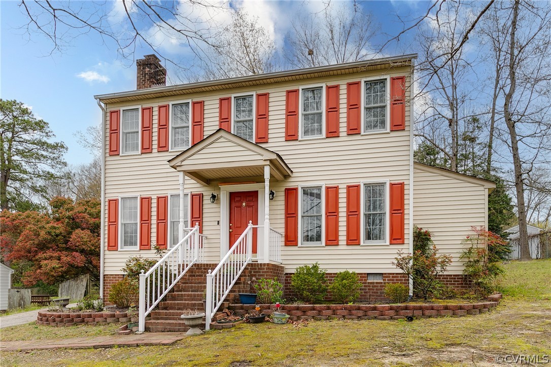 11036 Rufford Road Chester, VA 23831 - Photo 1 of 35 a front view of a house with a yard table and chairs