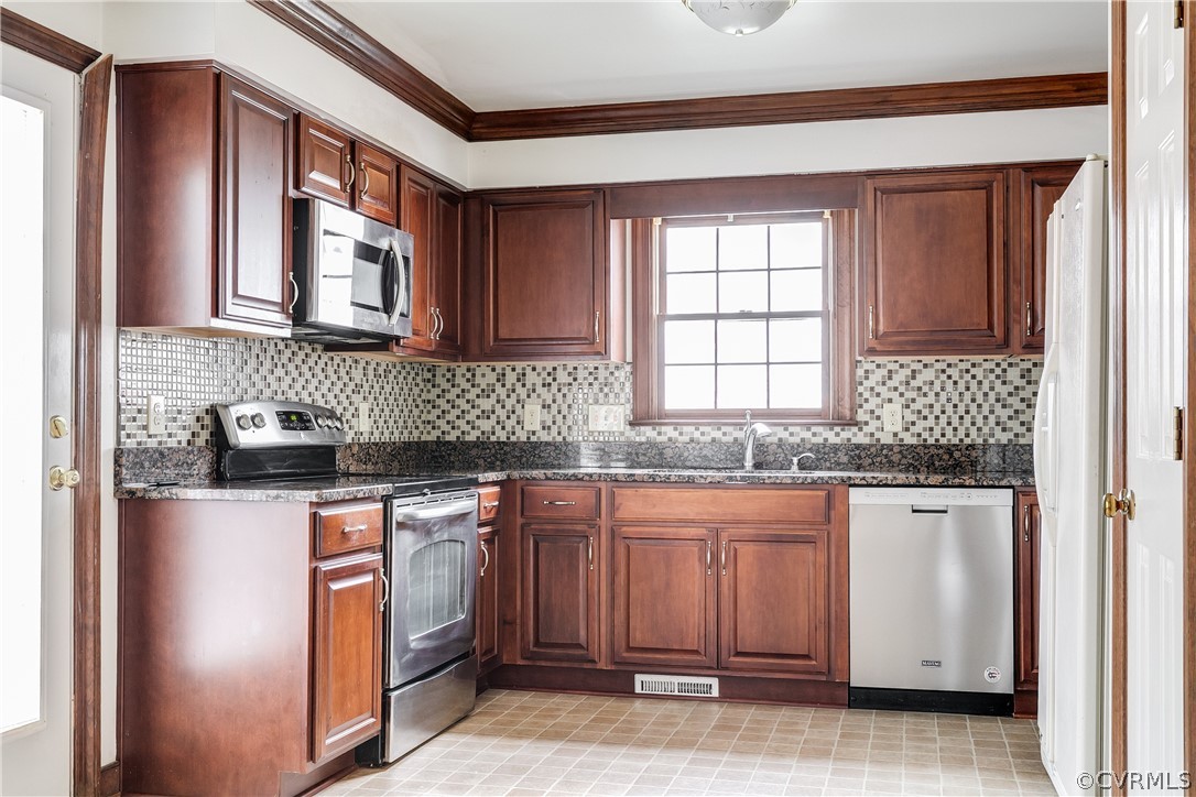 11036 Rufford Road Chester, VA 23831 - Photo 12 of 35 a kitchen with stainless steel appliances granite countertop a sink stove and cabinets